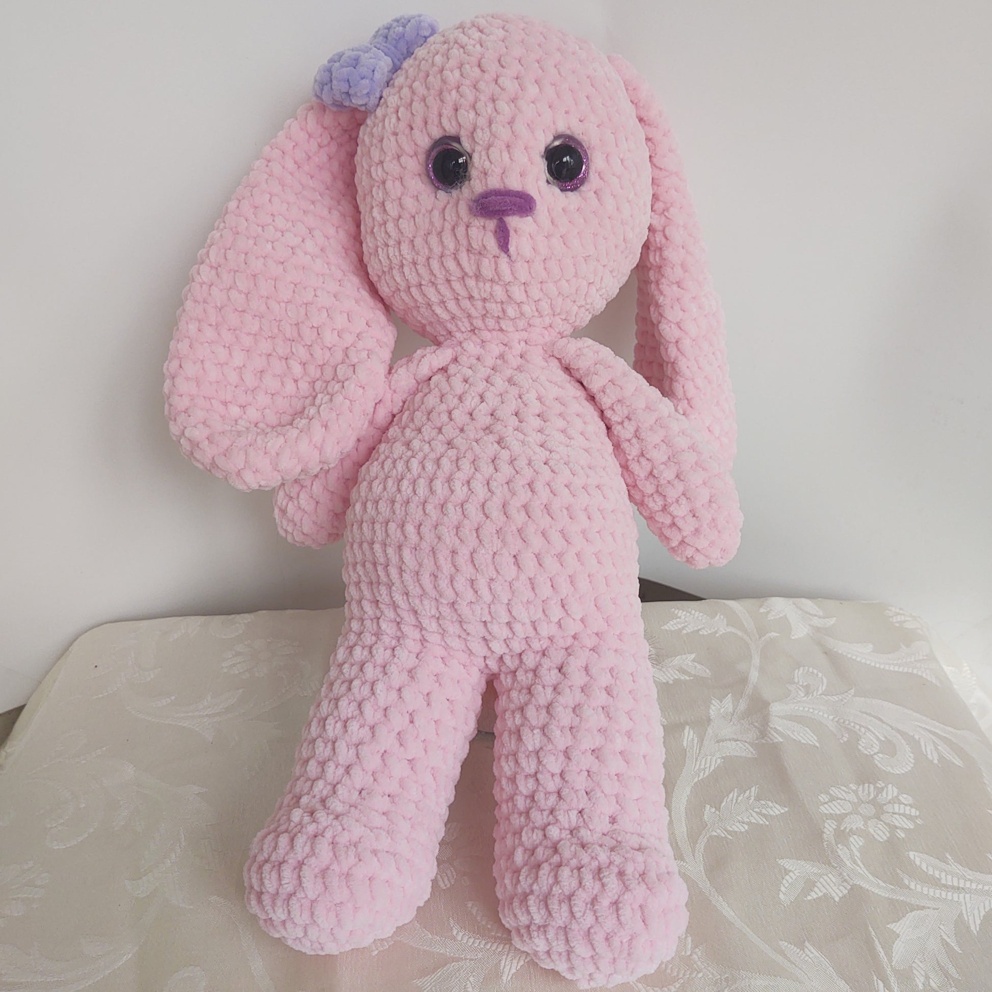 Front of plush bunny with violet bow