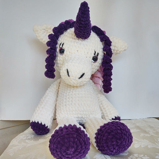 Sitting Unicorn with purple hooves and horn