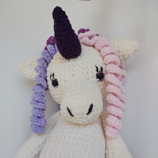 Face of purple hooved unicorn with pink and purple hair