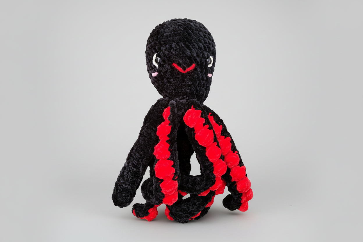 Black and red crochet stuffed octopus. 