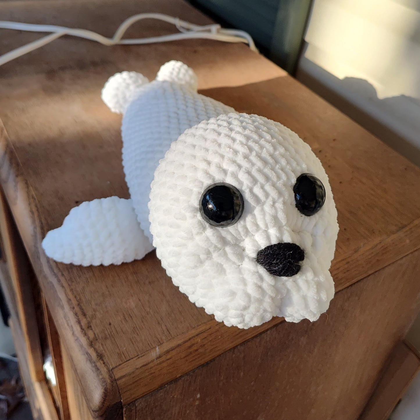 Snowflake the Harp Seal Pup – handmade crochet plush, white chenille, safety eyes and embroidered nose