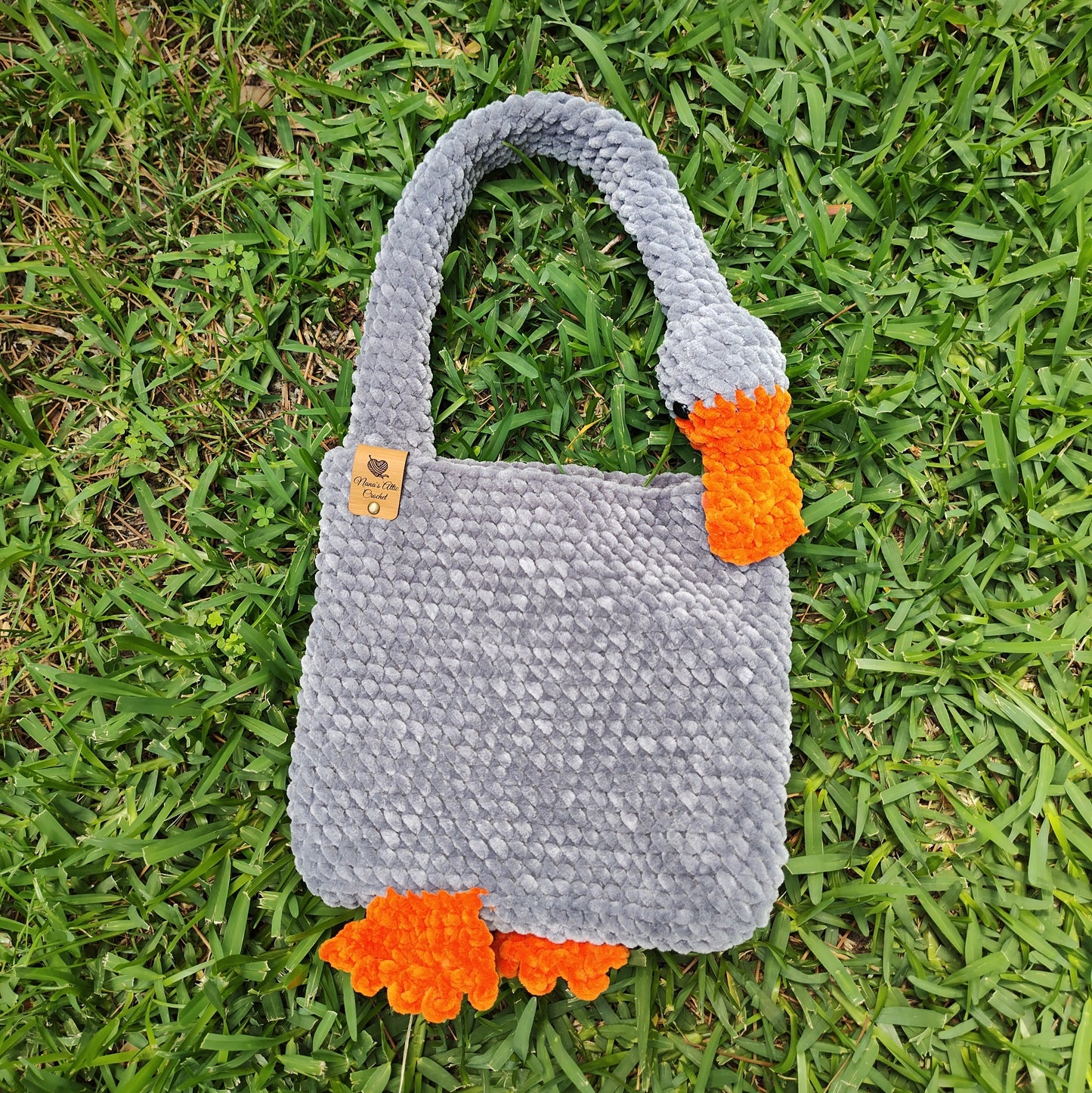 Gray goose handbag on a grassy background