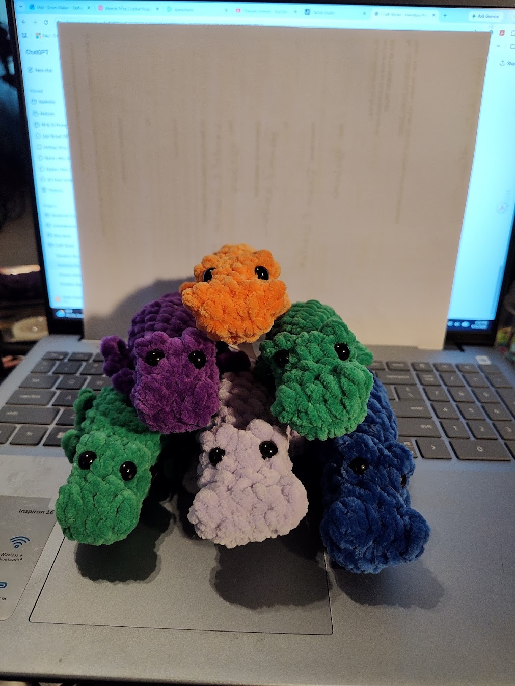 Handmade crocheted mini alligator plush toys in orange, purple, green, light green, cream, and dark blue