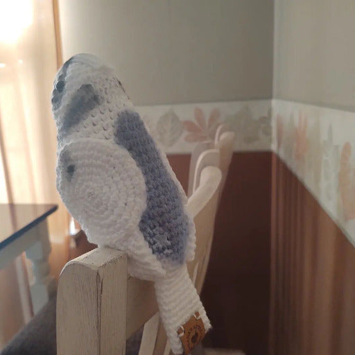 Gray budgie on chair back